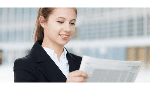 smiling woman reading newsletter