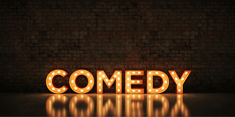 Comedy spelled out in stage lights on a dark background