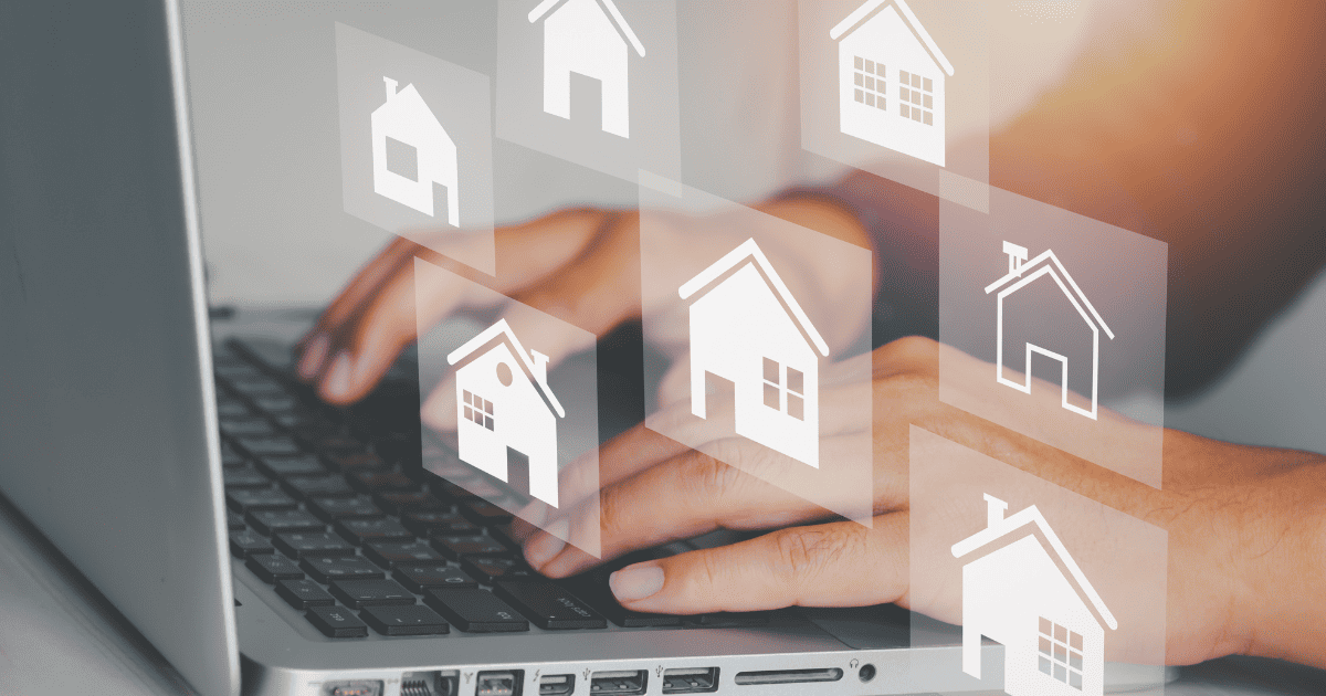 hands typing on keyboard with white images of real estate floating above