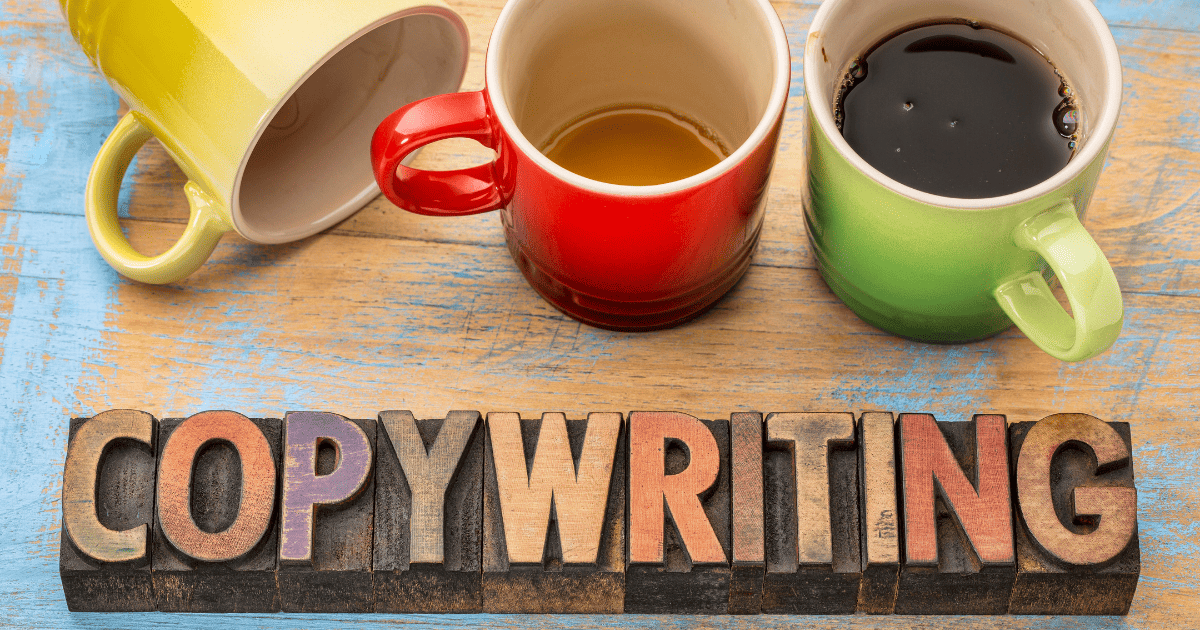 copywriting spelled out with wood blocks and 3 colorful coffee cups